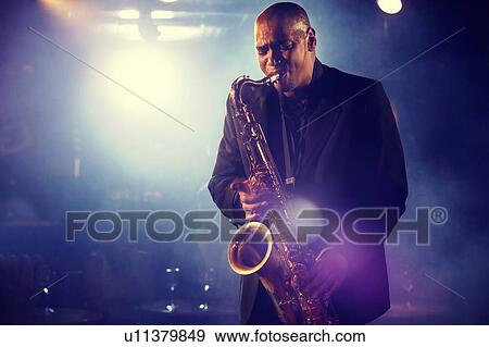 Stock Photo - Man Playing Saxophone on Stage. Fotosearch