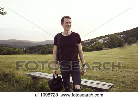 Man standing by bench, hills in background, Wilhelminenberg, Vienna, Austria View Large Photo Image Stock Photo - Man standing by bench, hills in background, Wilhelminenberg, Vienna, Austria. Fotosearch