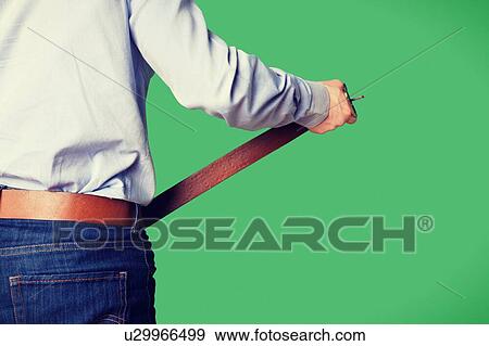 Man tightening his brown belt View Large Photo Image Stock Photo - Man tightening his brown belt. Fotosearch