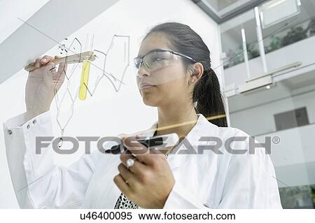 Medical student drawing atoms on glass wall in classroom View Large Photo Image Stock Photography - Medical student drawing atoms on glass wall in classroom. Fotosearch