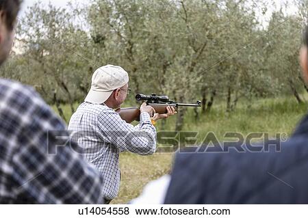 Men at rifle target shooting, Florence, Italy View Large Photo Image Stock Photo - Men at rifle target shooting, Florence, Italy. Fotosearch