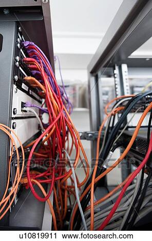 Stock Image - Messy cables in computer data center. Fotosearch