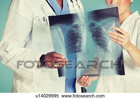 Stock Photography - Midsection of health care professionals analyzing x-ray report. Fotosearch
