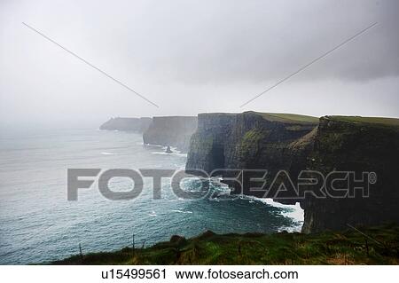 Stock Image - Misty view over Cliffs of Moher. Fotosearch