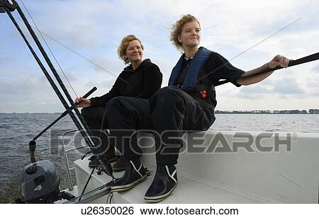 Stock Photograph - Mother and daughter sailing, Frisian Lake district, Netherlands. Fotosearch