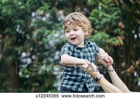 Mother playing with toddler in park View Large Photo Image Stock Photography - Mother playing with toddler in park. Fotosearch