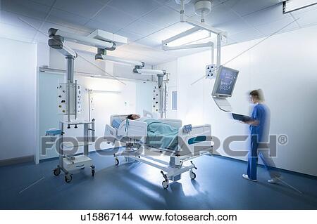 Picture - Nurse and patient in intensive care unit in hospital setting. Fotosearch