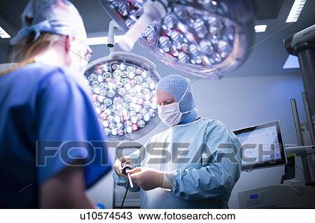 Nurse and surgeon in operating theatre in hospital setting View Large Photo Image Stock Image - Nurse and surgeon in operating theatre in hospital setting. Fotosearch