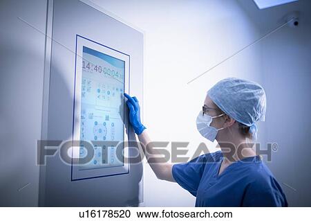 Nurse using operating theatre controls in operating theatre in hospital setting View Large Photo Image Stock Image - Nurse using operating theatre controls in operating theatre in hospital setting. Fotosearch