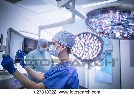 Nurse using operating theatre controls in operating theatre in hospital setting View Large Photo Image Stock Image - Nurse using operating theatre controls in operating theatre in hospital setting. Fotosearch