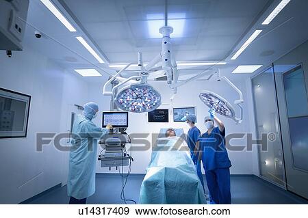 Stock Photo - Nurses, surgeon and patient in operating theatre in hospital setting. Fotosearch