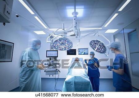 Nurses, surgeon and patient in operating theatre in hospital setting View Large Photo Image Stock Photo - Nurses, surgeon and patient in operating theatre in hospital setting. Fotosearch