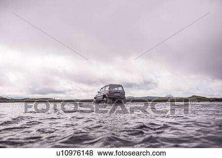 Stock Photo - Off road vehicle driving through water, Landmannalaugar, Iceland. Fotosearch