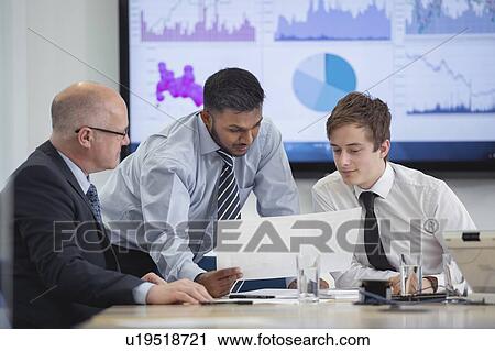 Office workers in meeting with graphs and charts View Large Photo Image Stock Image - Office workers in meeting with graphs and charts. Fotosearch