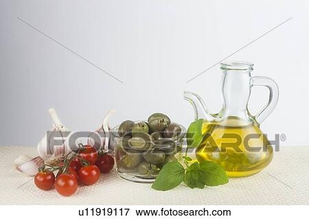 Stock Photo - Olive oil, basil, garlic and tomato. Fotosearch