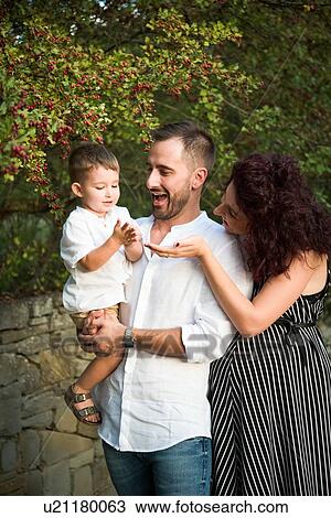 Stock Image - Parents with son in park. Fotosearch