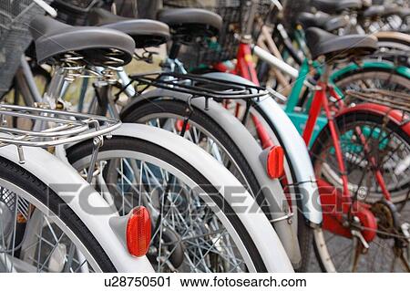 Stock Image - Parked Bicycles all together. Fotosearch