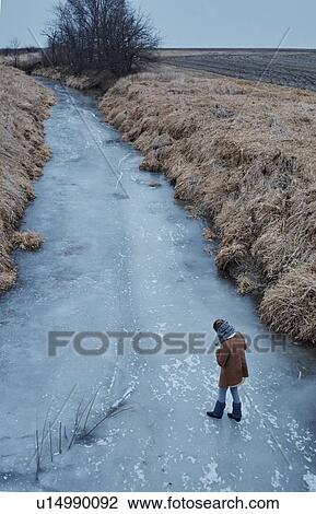 Person walking on frozen river, Champaign, Illinois, USA View Large Photo Image Stock Image - Person walking on frozen river, Champaign, Illinois, USA. Fotosearch