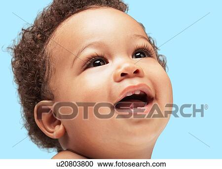 Photo of smiling black baby against blue background View Large Photo Image Stock Image - Photo of smiling black baby against blue background. Fotosearch