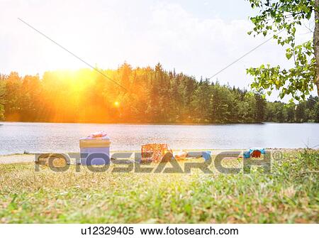 Stock Photography - Picnic gear on lakeshore. Fotosearch