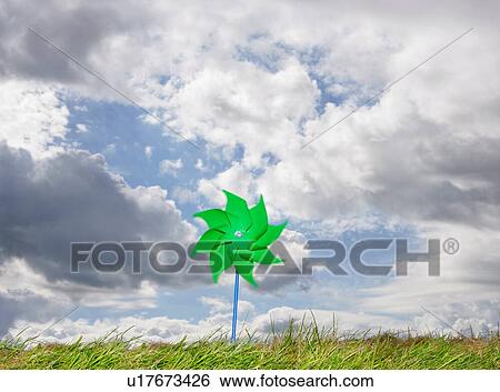 Stock Photograph - Pinwheel against cloudy sky. Fotosearch