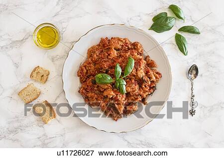 Plate of Pappa al pomodoro (Tuscan bread and tomato soup) garnished with basil, olive oil and bread on side View Large Photo Image Stock Photo - Plate of Pappa al pomodoro (Tuscan bread and tomato soup) garnished with basil, olive oil and bread on side. Fotosearch