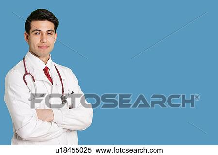 Portrait of an Indian male healthcare professional standing with arms crossed View Large Photo Image Stock Photography - Portrait of an Indian male healthcare professional standing with arms crossed. Fotosearch