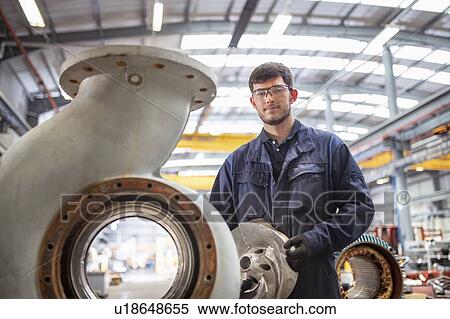 Portrait of apprentice engineer with snail shaped pump housing in electrical engineering factory View Large Photo Image Stock Photography - Portrait of apprentice engineer with snail shaped pump housing in electrical engineering factory. Fotosearch