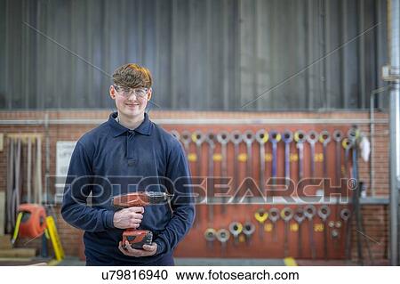 Stock Image - Portrait of apprentice timber mould maker in steelworks. Fotosearch