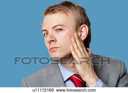 Portrait of businessman with hand on cheek View Large Photo Image Stock Photo - Portrait of businessman with hand on cheek. Fotosearch