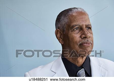 Portrait of senior businessman, blue background View Large Photo Image Stock Image - Portrait of senior businessman, blue background. Fotosearch