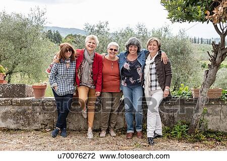 Stock Image - Portrait of senior women, olive trees in background, Florence, Italy. Fotosearch