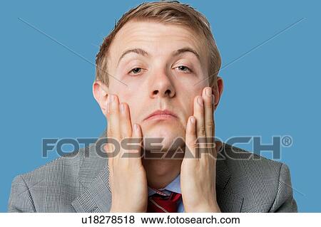 Stock Photo - Portrait of tired young businessman. Fotosearch