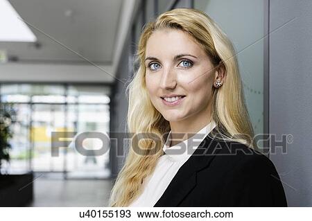 Stock Image - Portrait of young businesswoman in office. Fotosearch