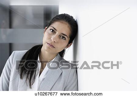 Stock Photo - Portrait of young businesswoman in corridor of building. Fotosearch