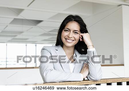 Stock Photo - Portrait of young businesswoman in corridor of building. Fotosearch