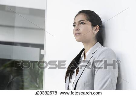 Portrait of young businesswoman in corridor of building View Large Photo Image Stock Photo - Portrait of young businesswoman in corridor of building. Fotosearch