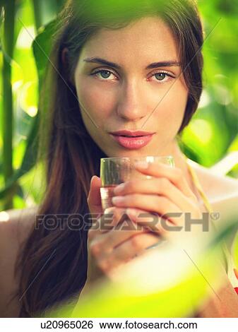 Portrait of young woman in corn field with drinking glass View Large Photo Image Stock Photograph - Portrait of young woman in corn field with drinking glass. Fotosearch