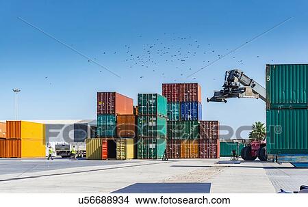 Reach stacker and shipping containers in dock View Large Photo Image Picture - Reach stacker and shipping containers in dock. Fotosearch