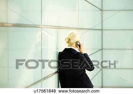 Rear view of Businesswoman Using Cell Phone View Large Photo Image Stock Photo - Rear view of Businesswoman Using Cell Phone. Fotosearch