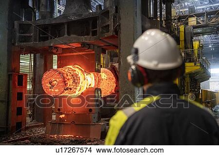 Red hot steel ingot in steel press in steelworks View Large Photo Image Picture - Red hot steel ingot in steel press in steelworks. Fotosearch