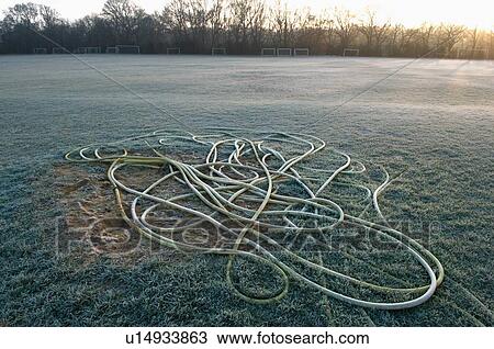 Stock Image - Rope on empty soccer field sunset. Fotosearch