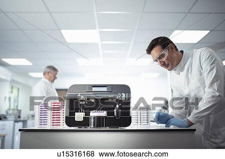 Scientist operating agar dish coating machine in laboratory View Large Photo Image Stock Photo - Scientist operating agar dish coating machine in laboratory. Fotosearch