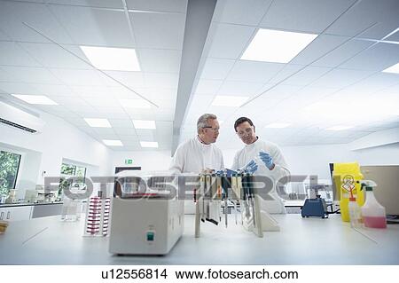 Scientists in discussion in laboratory View Large Photo Image Picture - Scientists in discussion in laboratory. Fotosearch
