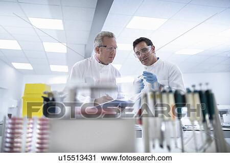 Scientists in discussion in laboratory View Large Photo Image Stock Image - Scientists in discussion in laboratory. Fotosearch