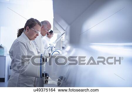 Scientists working with anaerobic cabinets in laboratory View Large Photo Image Picture - Scientists working with anaerobic cabinets in laboratory. Fotosearch