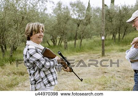 Senior woman at rifle target shooting, Florence, Italy View Large Photo Image Stock Photo - Senior woman at rifle target shooting, Florence, Italy. Fotosearch