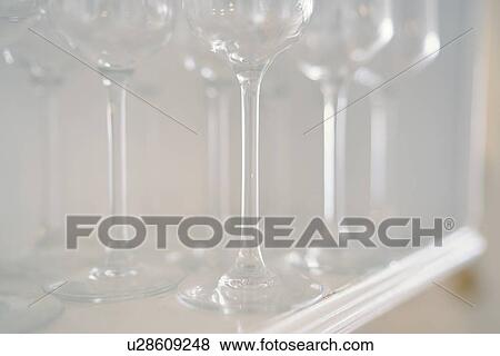 Stock Photo - Shelf of wine glasses. Fotosearch