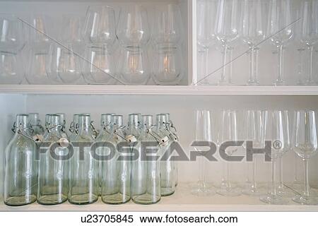 Shelves of wine glasses and glass bottles View Large Photo Image Stock Photography - Shelves of wine glasses and glass bottles. Fotosearch