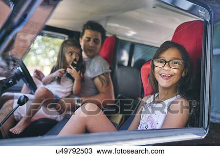 Siblings sitting in car with father View Large Photo Image Stock Image - Siblings sitting in car with father. Fotosearch